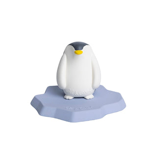 Oli & Carol penguin standing on blue iceberg base, natural rubber baby bath toy with hand-painted yellow beak