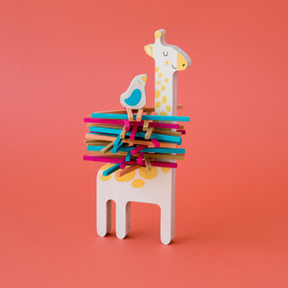 Birch wood giraffe with sticks balanced to build a nest and small bird placed on top, Londji Matilda and Friend friendship stacking game in sustainable wood