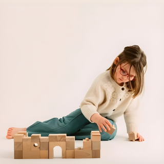 Kid stacking and building with Brick A Block Starter 24 natural beech wood blocks, classic open-ended construction play developing balance, coordination and spatial awareness