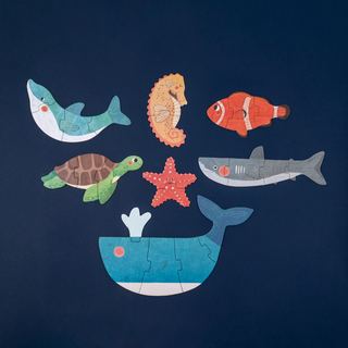 Progressive toddler puzzle pieces showing whale, dolphin, shark and seahorse in 2-to-5-piece sets, Londji Blue Puzzle chunky ocean jigsaw for small hands
