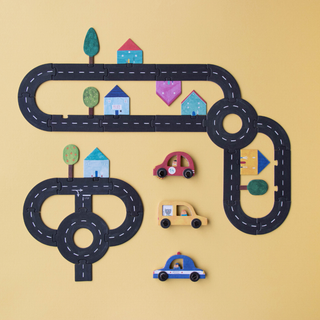 Road building game open with connecting pieces forming circuit, 6 colourful toy cars and model booklet, Londji Roads Family Game with over 1000 road combinations