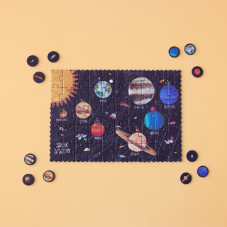 Completed 50-piece tiny solar system jigsaw with planet discovery cards teaching diameter and day length, Londji Discover the Planets Tiny pocket puzzle for children
