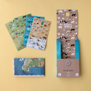 Large world map poster with animal stickers placed across continents showing wildlife habitats, Londji Animal World educational geography activity and room decoration